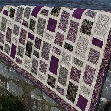Brick pattern quilt in grey and purple