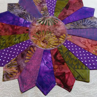 Dresden plate quilt in purple batiks